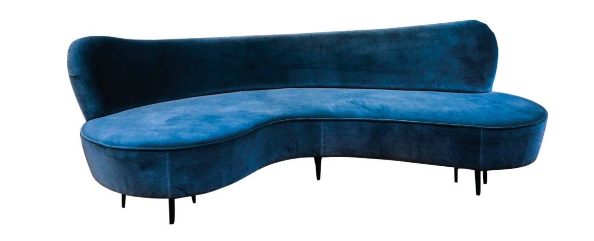 Curved dark blue velvet sofa with black legs on a white background.