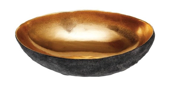 Golden textured bowl with a dark exterior, viewed from an angle, showcasing its lustrous reflective interior finish.