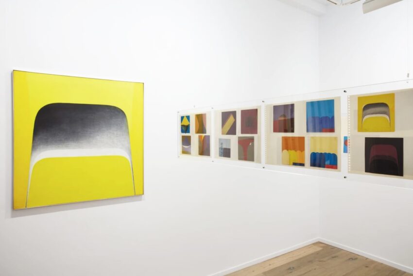 Gallery wall featuring abstract paintings with vibrant colors, including a large yellow canvas and a series of smaller artworks.