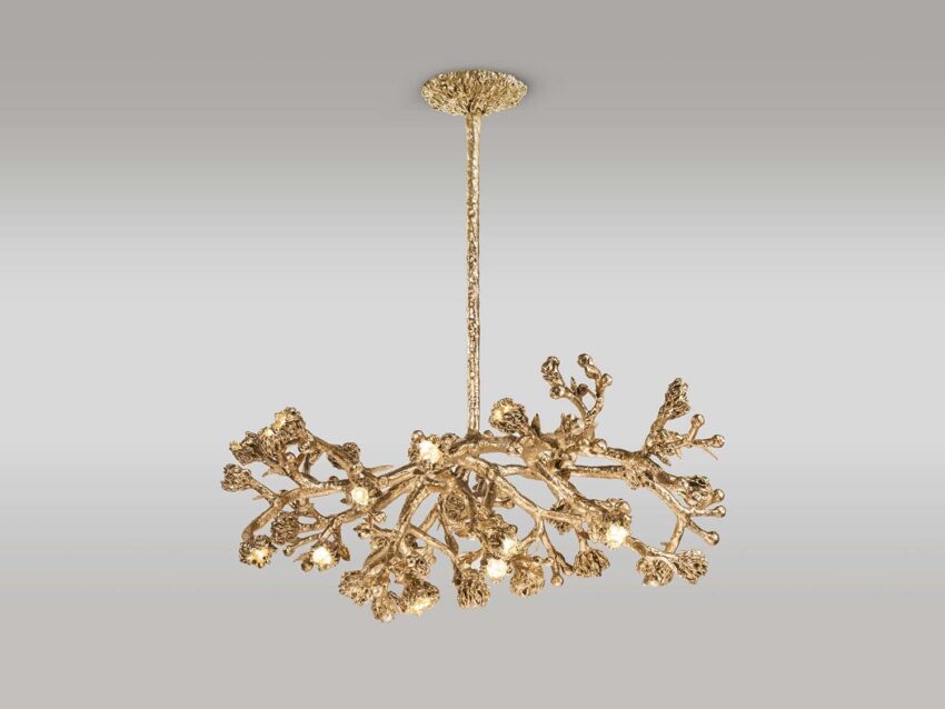 Elegant gold chandelier with intricate branch-like design suspended from ceiling on a gray background.