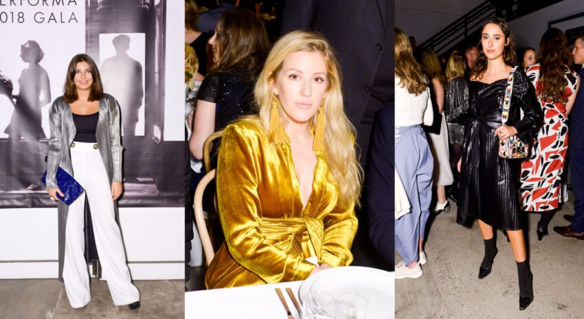 Three women at a gala event, dressed in stylish outfits, standing and sitting at a dinner table.