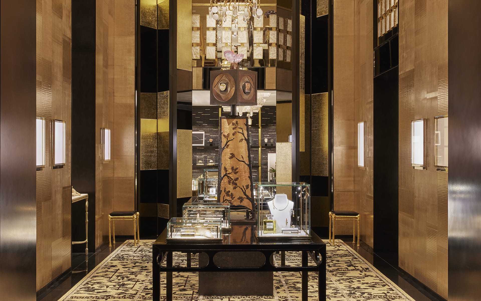 Luxury jewelry store interior with elegant decor, glass display cases, ornate chandelier, and plush carpeting.