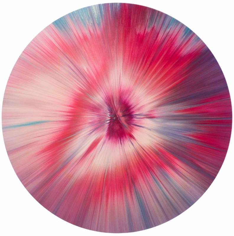 Abstract circular painting with vibrant pink, red, and blue hues radiating from the center outward.