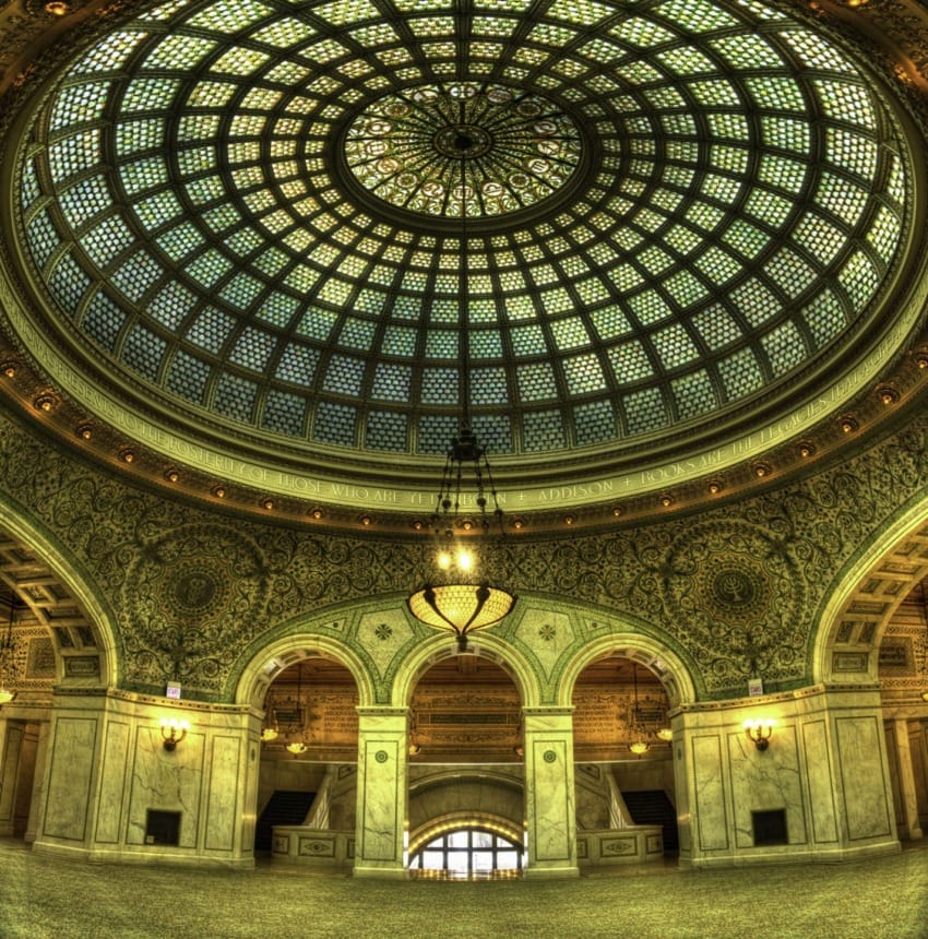 Ornate domed ceiling with intricate stained glass and detailed architectural design in a grand interior setting.