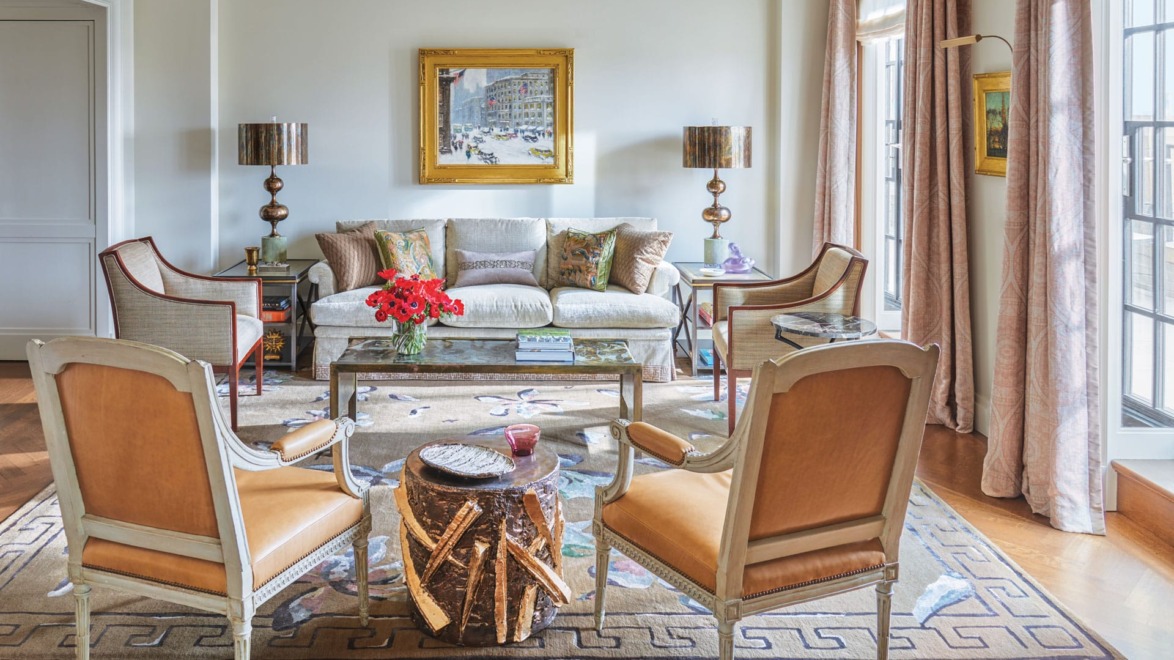 In the living room of an apartment that architect Lee Ledbetter designed for an art-collecting couple at The Carlyle hotel in New York, a Guy C. Wiggins painting overlooks a custom sofa flanked by 1940s French lounge chairs and a ’60s Philip and Kelvin LaVerne cocktail table. They are joined by brass lamps by Sylvan S.F., Louis XVI armchairs by Claude II Sene, and a Peter Lane ceramic drum table. A Paul Cornoyer painting hangs between the French doors, which are curtained in a Cowtan & Tout fabric.