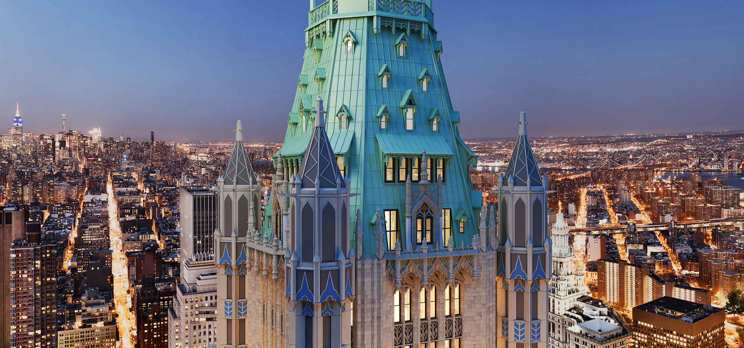Gothic-style skyscraper with pointed towers, set against a city skyline at dusk.