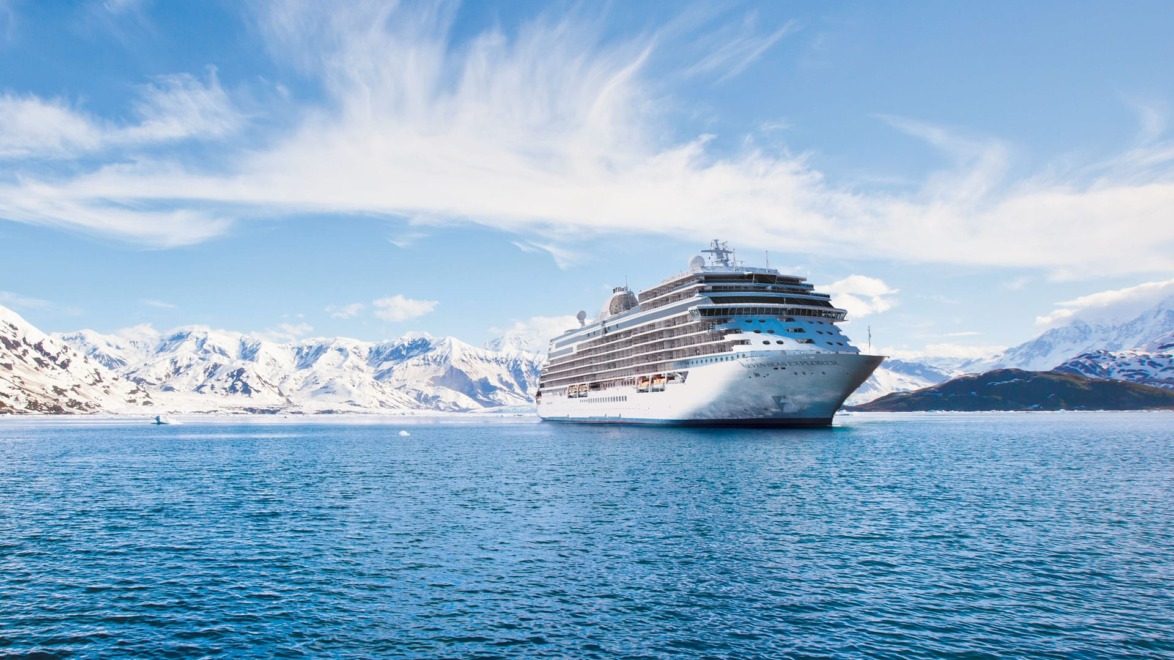 The Regent Seven Seas Explorer cruises past the majestic Alaskan coastline.