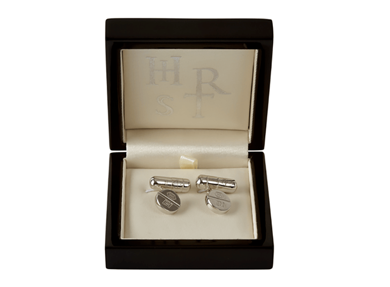 silver cufflinks in black box with initials embroidered on cream satin interior