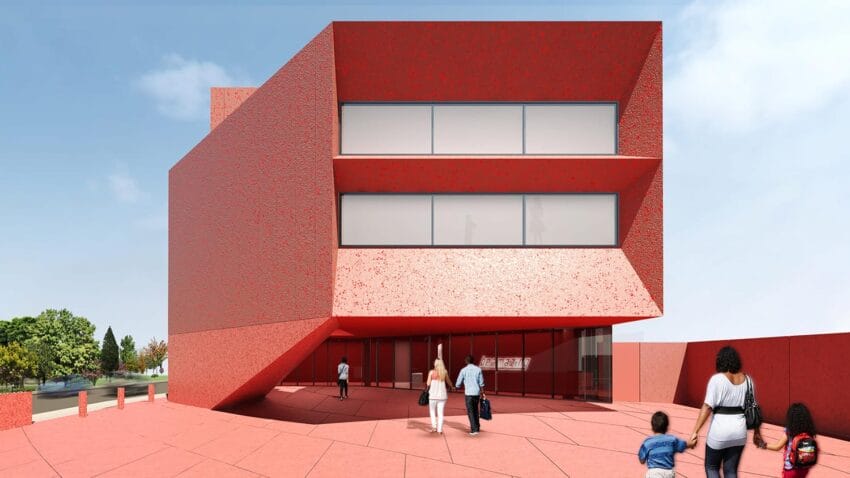 Modern red building with angular design and large windows, people walking nearby under a clear sky.