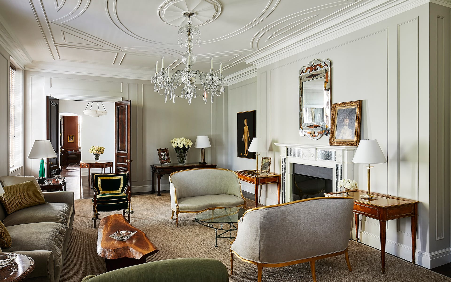 The sitting room of a Sutton Place apartment that David Kleinberg designed for Thom Browne, which appears in the new book “David Kleinberg: Interiors” (Phaidon). A pair of 18th-century George III settees flank a low table by Diego Giacometti. A 1948 églomisé mirror by Robert Pansart hangs above the fireplace, and the coffee table is by George Nakashima.