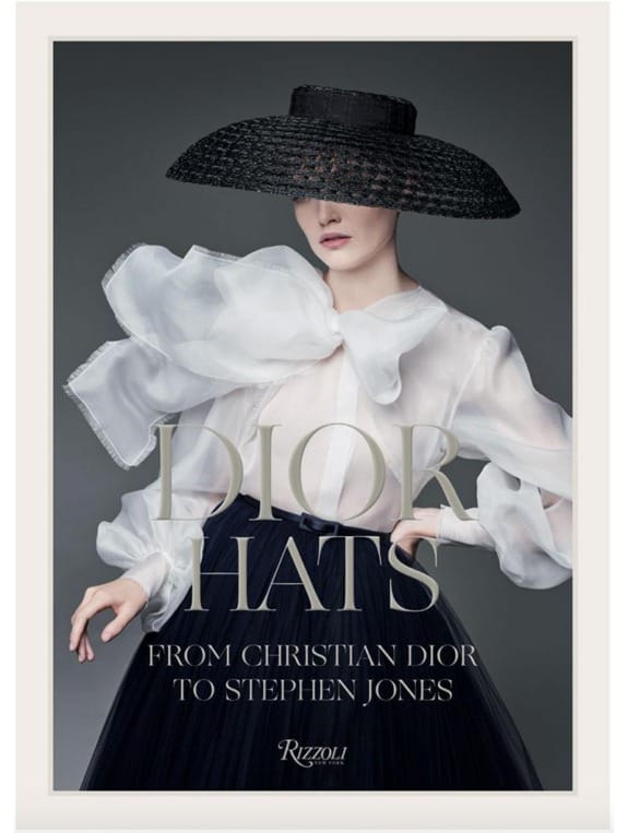 Fashion book cover featuring a model in a large black hat, sheer white blouse, and the text "Dior Hats" and "Rizzoli."