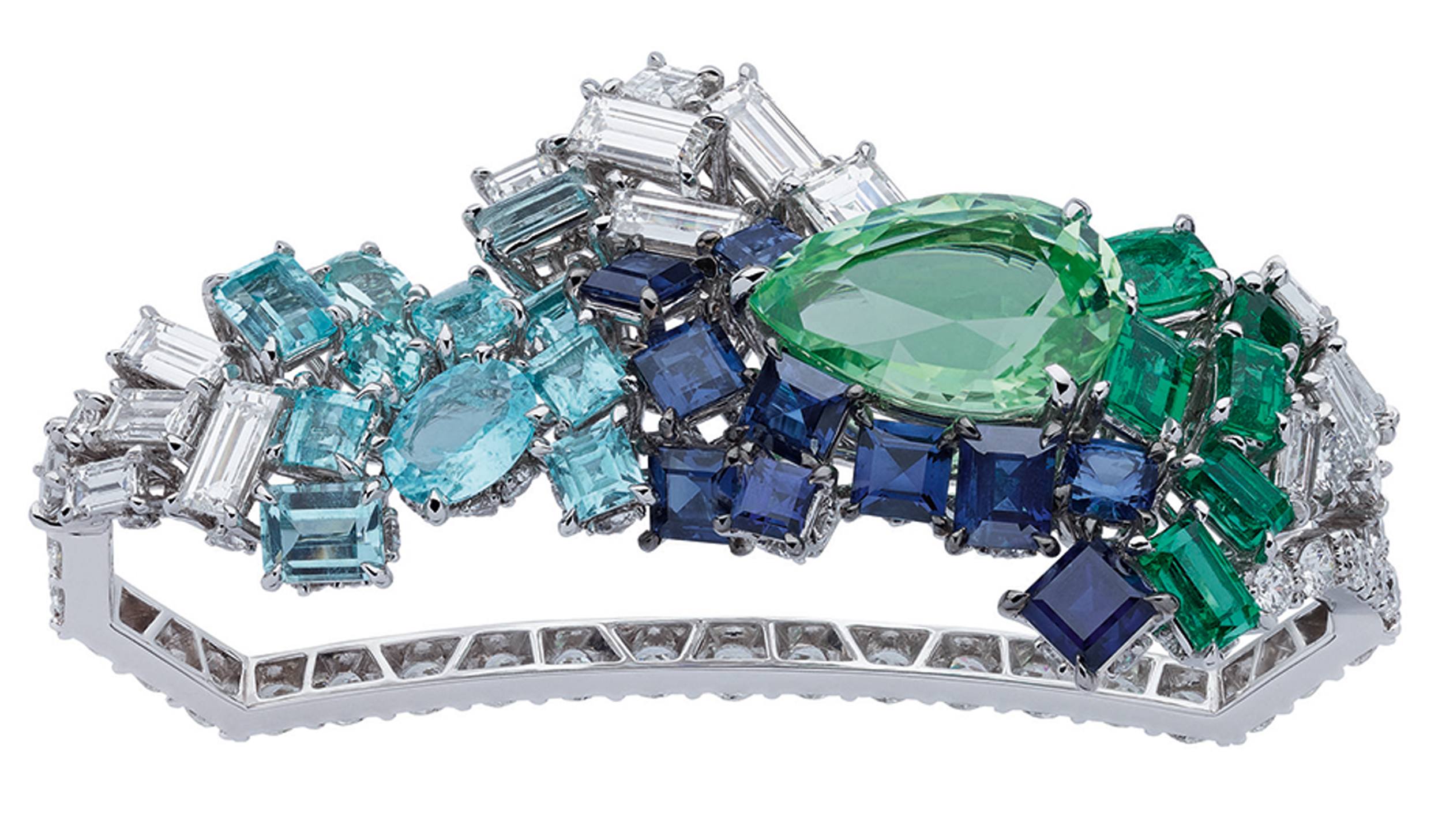 Ornate bracelet featuring a large green gemstone surrounded by blue, teal, and clear stones set in a silver band.