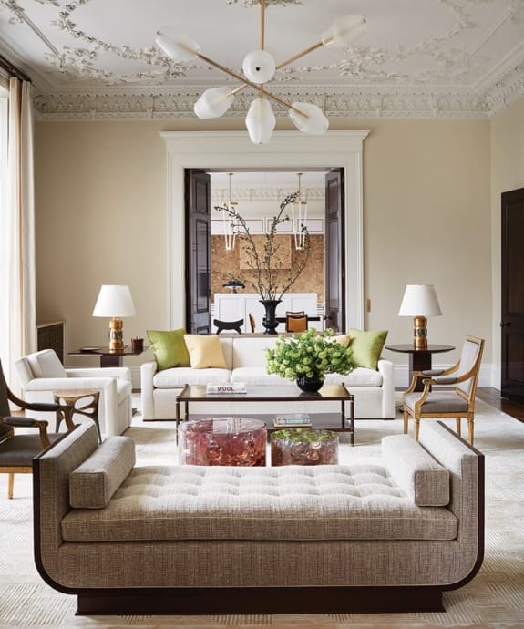 A chandelier by Régis Botta for Ozone hangs above the sitting area, where Kleinberg designed the sofa and armchair, both covered in a Pierre Frey fabric; the mahogany cocktail table; and the daybed. Joining the mix are pinkish crystal-resin drum tables by Atta and a custom rug by Edward Fields.