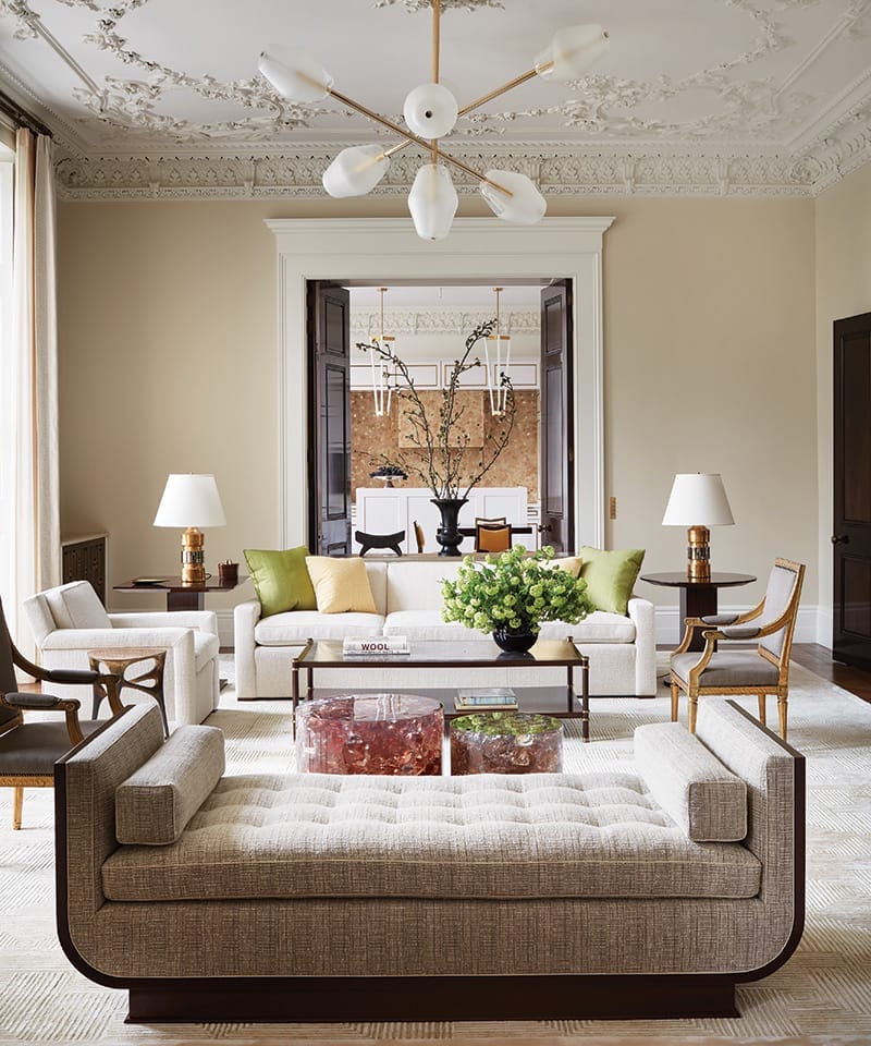 A chandelier by Régis Botta for Ozone hangs above the sitting area, where Kleinberg designed the sofa and armchair, both covered in a Pierre Frey fabric; the mahogany cocktail table; and the daybed. Joining the mix are pinkish crystal-resin drum tables by Atta and a custom rug by Edward Fields.