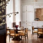 In the dining area near the open kitchen, Kleinberg installed a pair of custom pedestal tables and lacquered mahogany chairs beneath a pendant by Michael Anastassiades.