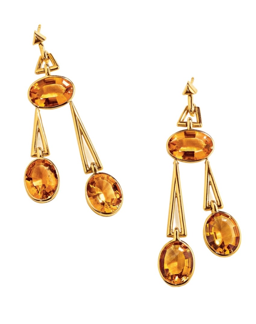 Gold earrings with multiple amber gemstones in geometric design.
