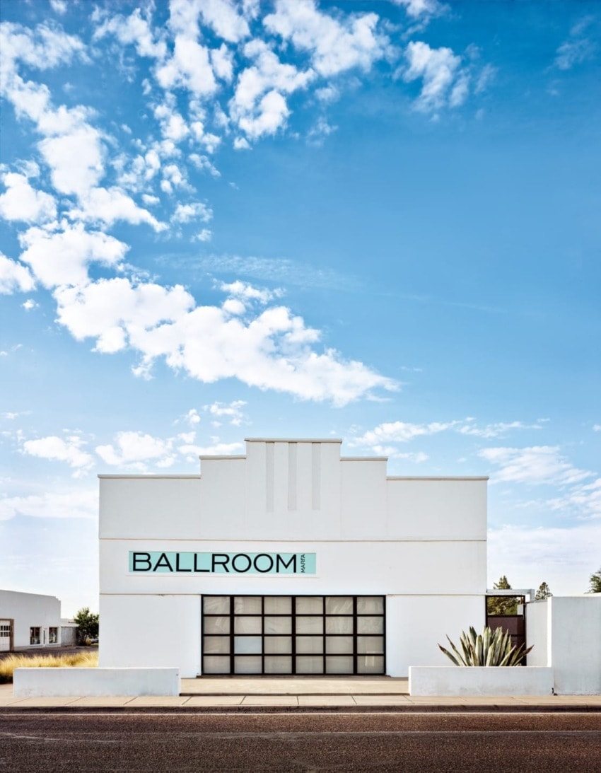 White building labeled Ballroom Marfa under a blue sky with clouds.