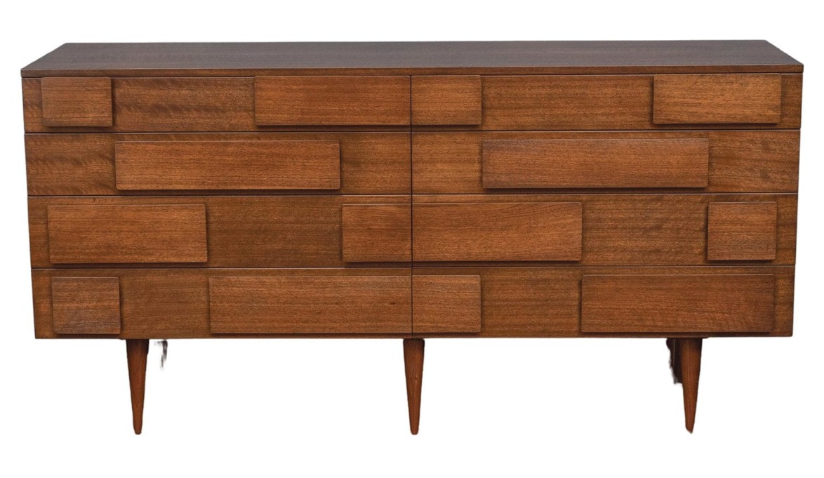 Mid-century modern wooden dresser with six drawers and tapered legs.