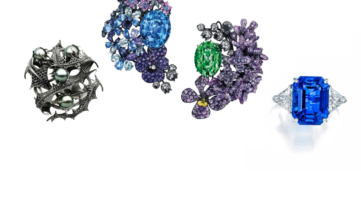 Four ornate jewelry pieces with colorful gemstones, including blue and green stones, set in intricate designs.