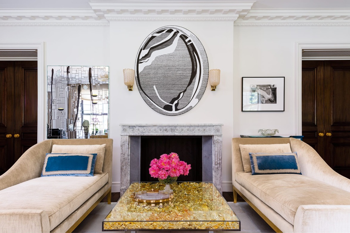 Two chaise longues frame the fireplace. The star of the room is an Yves Klein Table D’Or, from 1963, with 3,000 sheets of gold leaf. Mirror #1, an oil and magna on canvas by American Pop artist Roy Lichtenstein, from 1969, takes center stage above the marble mantel. To its right is Cindy Sherman’s 1978 Untitled Film Still #11. To its left is the 2011 mirror piece three butters by the american artist Rashid Johnson.