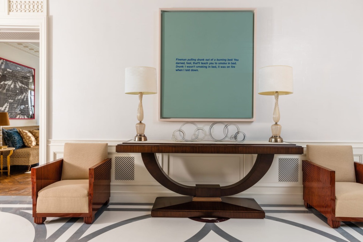 A pair of 1930s French mahogany bergeres flank a mahogany-and-shagreen console made by Beacon, New York-based Mark Luedeman, in a French 1930s style. The lamps are from Carlos de la Puente Antiques, in New York. The 1989 acrylic and silkscreen on canvas work is by American artist Richard Prince and is titled Fireman and Drunk.