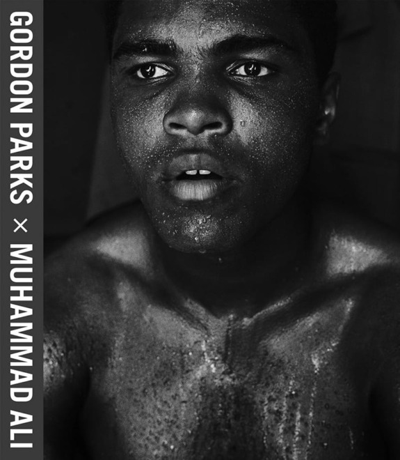 Young boxer with sweat-drenched skin, intense expression, black and white photograph by Gordon Parks.