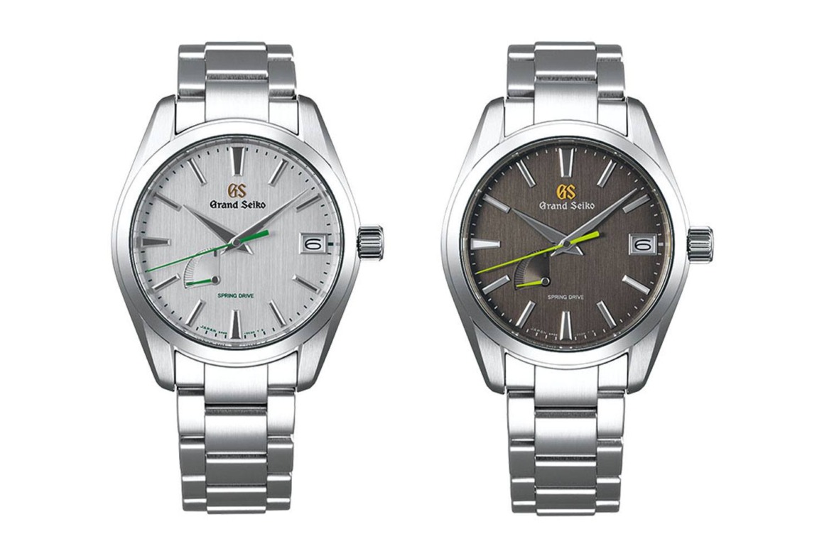 Two Grand Seiko watches with silver and dark grey dials, featuring stainless steel bands and date display at 3 o'clock.