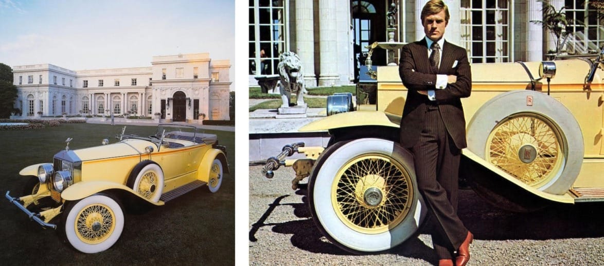 Vintage yellow convertible car parked in front of a grand estate with a man in a suit leaning on the car.