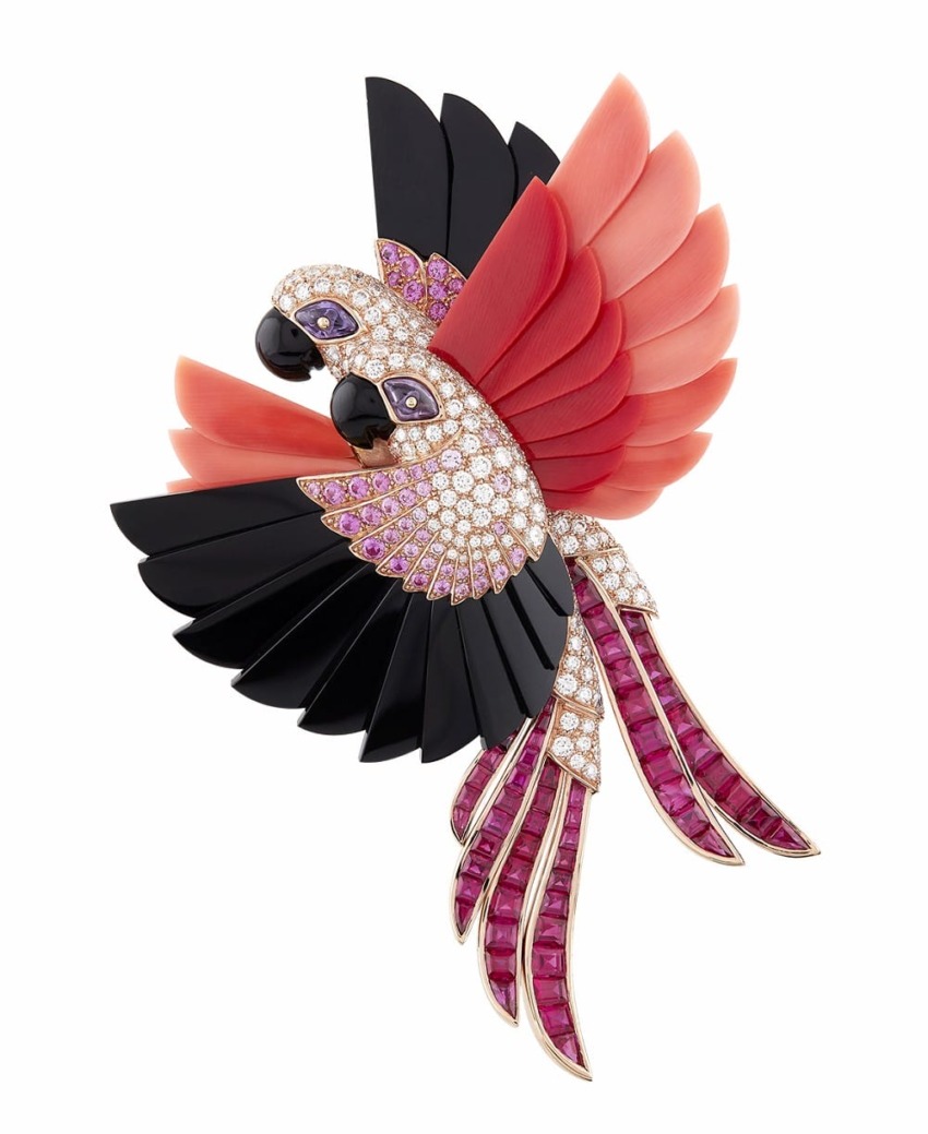 Colorful parrot brooch with red, black, and pink gemstones, featuring intricate feather detailing.