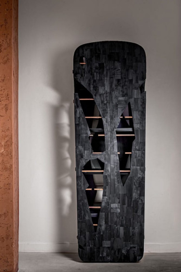 Unique dark wooden cabinet with abstract cutouts and visible shelves against a minimalist background.