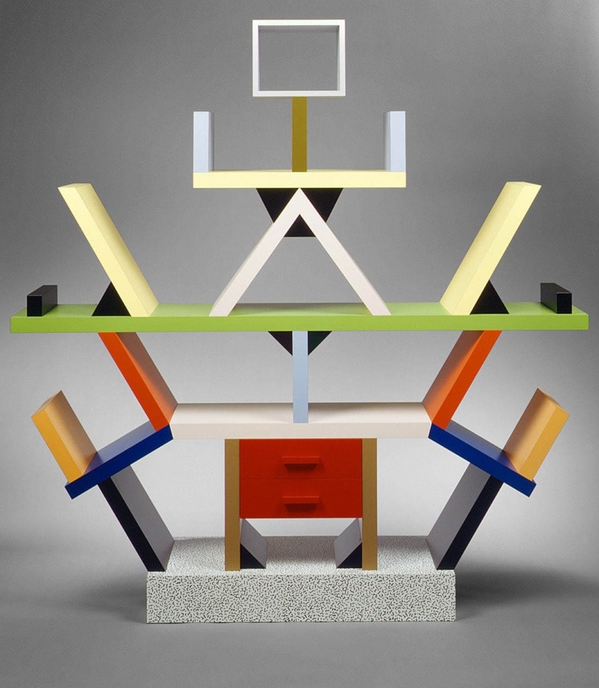 Colorful, abstract Memphis-style shelf with geometric shapes and bold patterns against a neutral background.