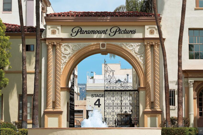 Entrance archway to Paramount Pictures with ornate design and view of Stage 4 gate in the background.