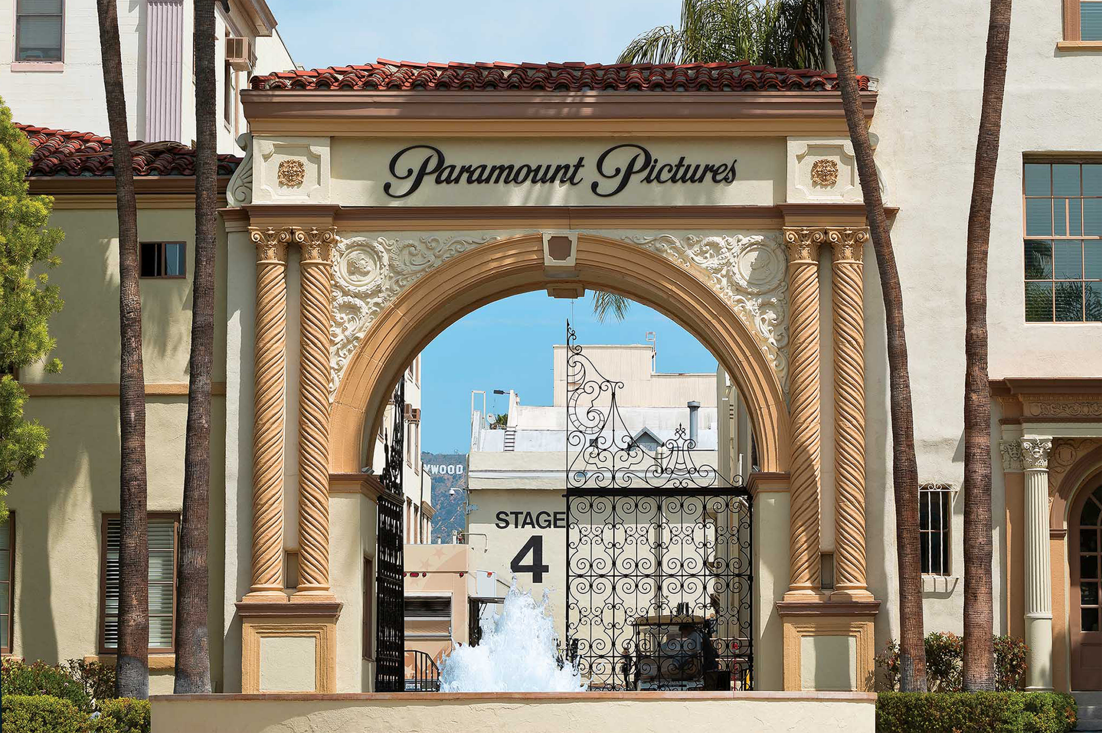 Entrance archway of Paramount Pictures studio with "Stage 4" and palm trees in the background.