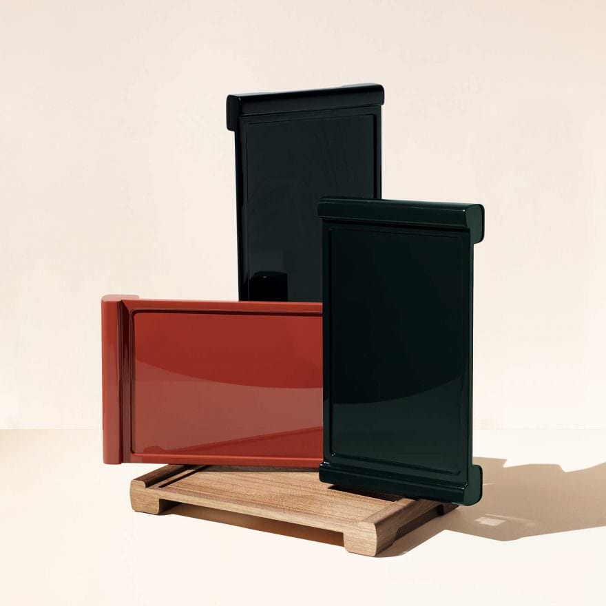 Colorful rectangular ceramic vases displayed on a wooden stand against a neutral background.