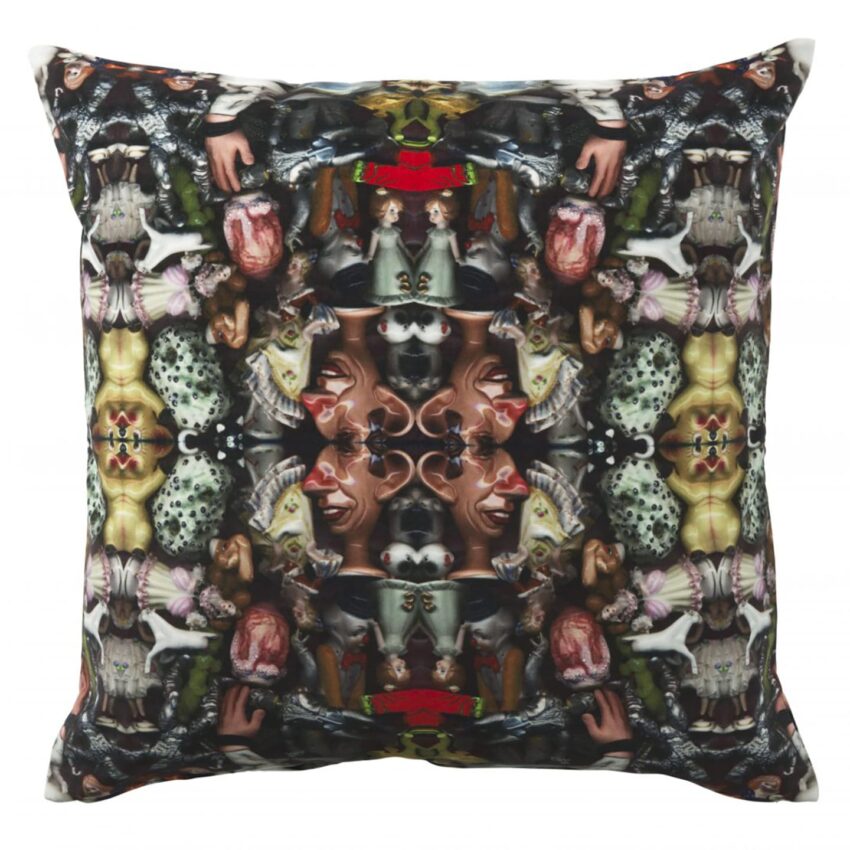 Kaleidoscopic pillow design with intricate patterns of animals and faces in a vibrant, colorful display.