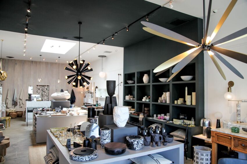 Modern interior design store with stylish decor items, contemporary lighting fixtures, and creative shelving displays.