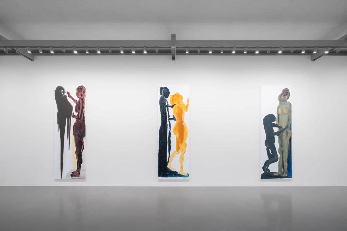 Art gallery with three abstract paintings depicting human figures in varying colors and poses on a white wall.