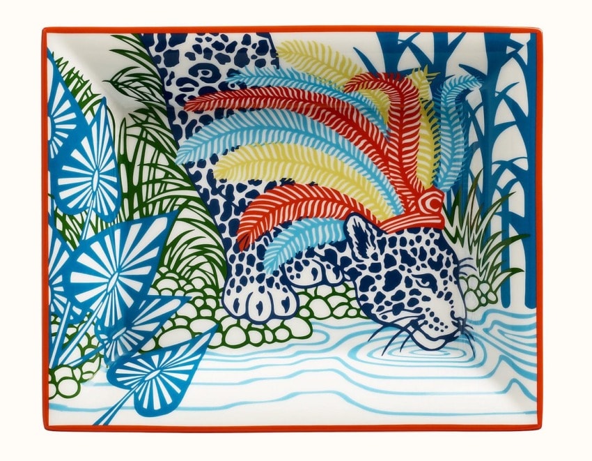 Colorful plate featuring a patterned jaguar drinking from a stream, surrounded by vibrant tropical foliage.