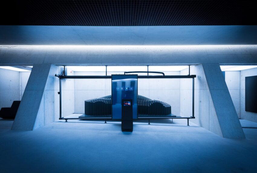 Futuristic indoor charging station with a sleek design, glowing blue lights, and high-tech interface in a modern setting.