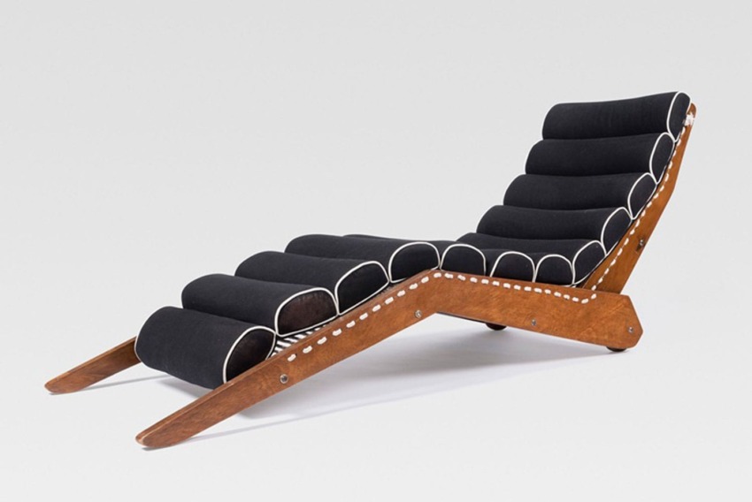 Modern black chaise lounge with white accents and wooden frame on white background