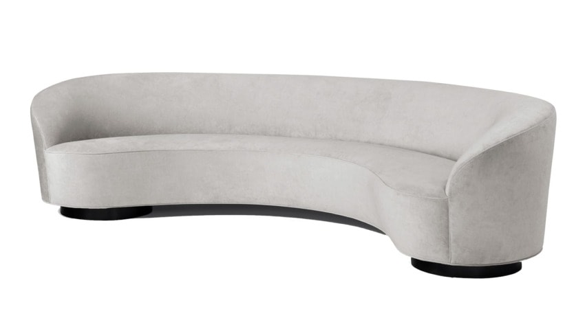 Elegant curved gray sofa with plush upholstery and black circular legs, perfect for modern living rooms or lounge areas.