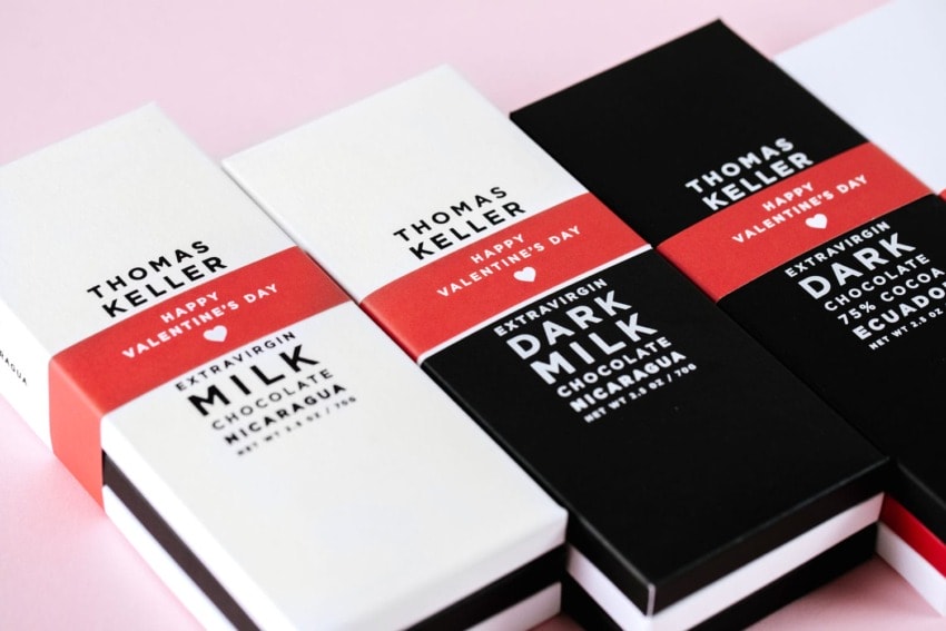 Valentine's Day chocolate bars wrapped in red and black with labels for extra virgin milk and dark chocolate from Nicaragua.