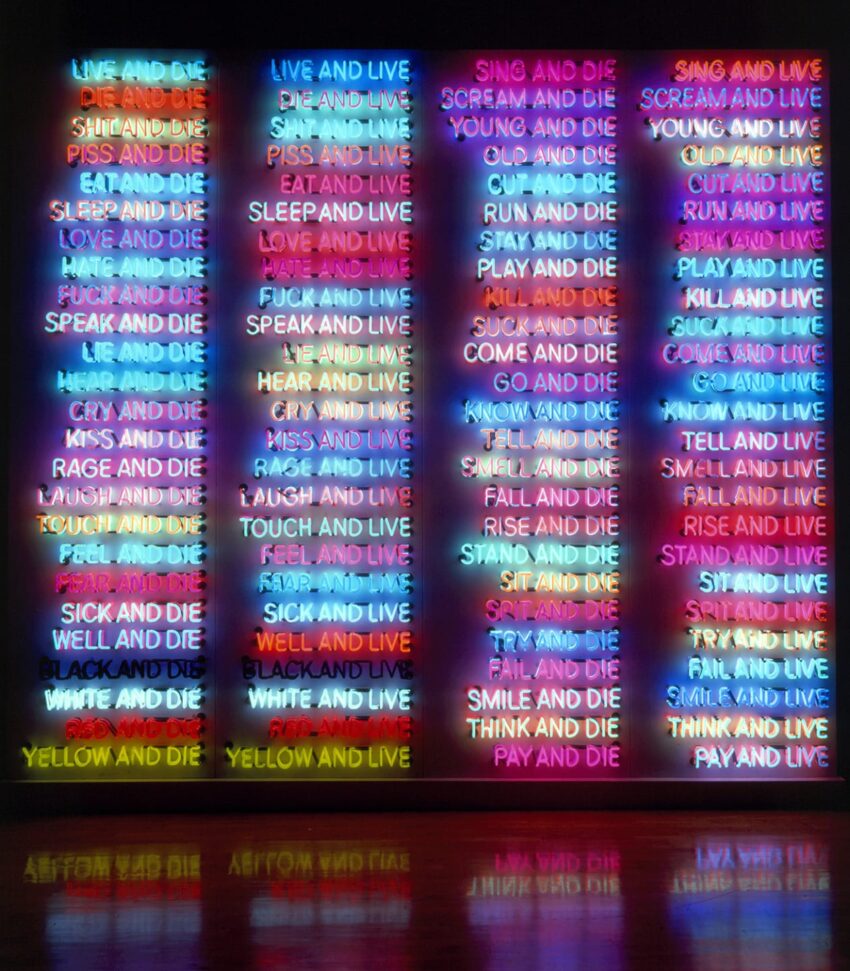 Colorful neon art installation with vertical panels, each displaying various phrases about living and dying in different hues.