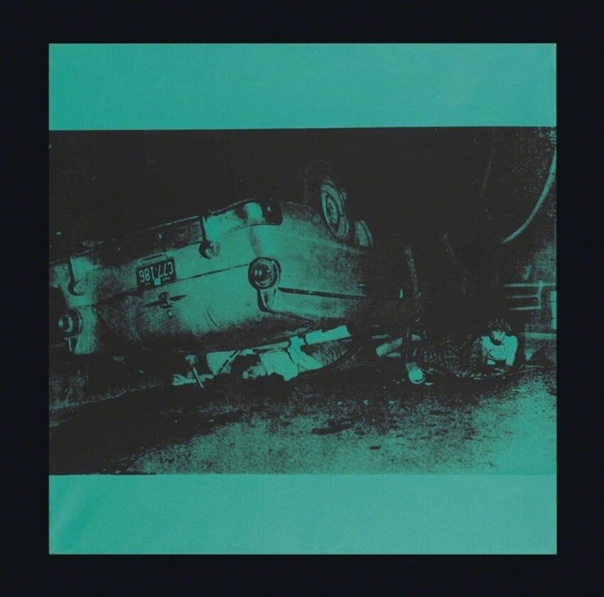 Overturned car on dark street with visible license plate and scattered debris, creating a dramatic scene.