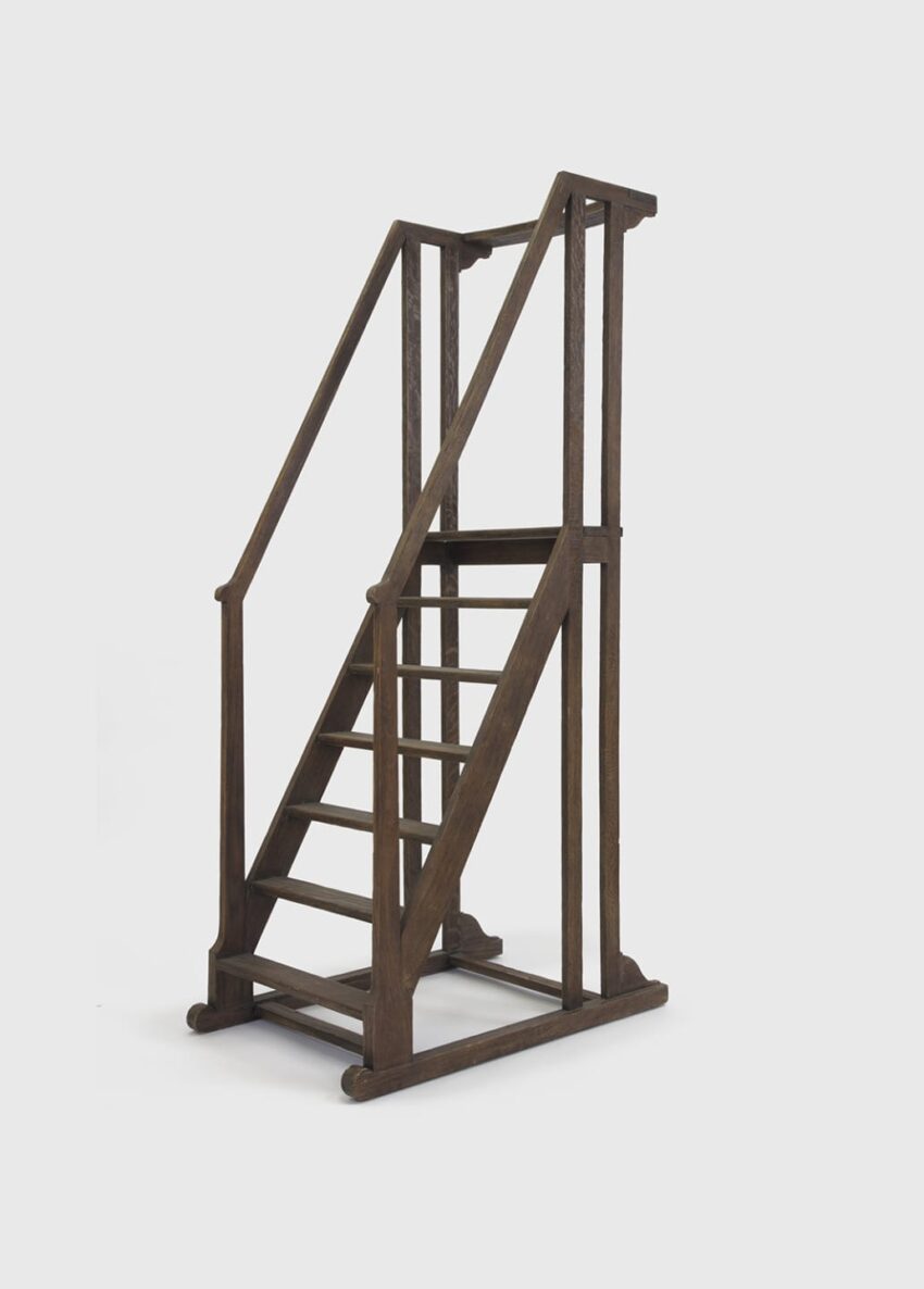 Tall wooden stepladder with handrails, featuring six steps, designed for interior use or decorative purposes.