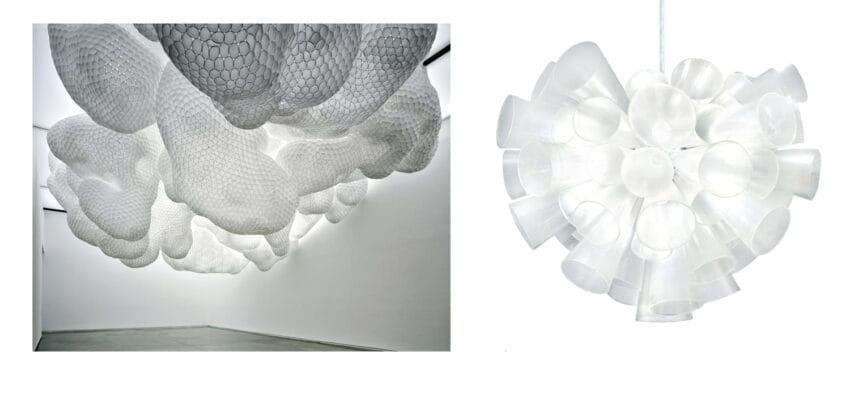 Abstract cloud-like sculpture installation in an art gallery, alongside a spherical light fixture made of translucent cups.