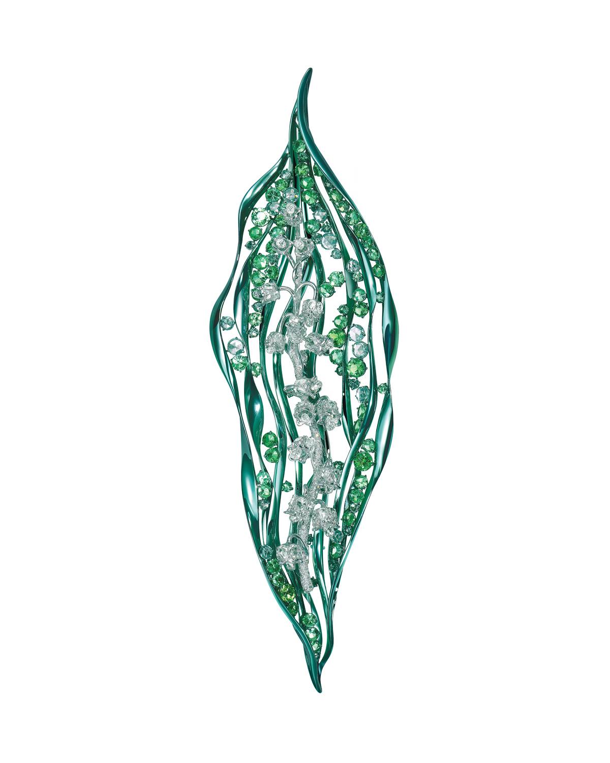 Elegant leaf-shaped brooch with green and silver accents, featuring intricate detailing and sparkling gemstones.