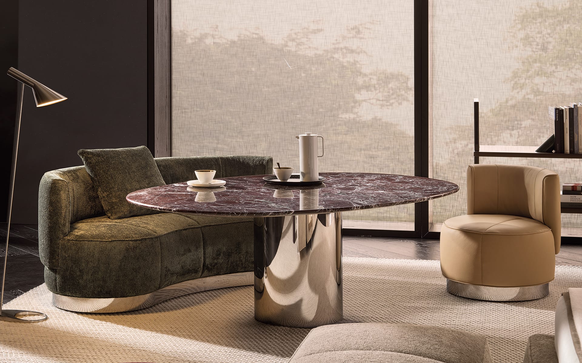 Modern living room with a marble table, green sofa, beige chair, and a floor lamp next to large windows.
