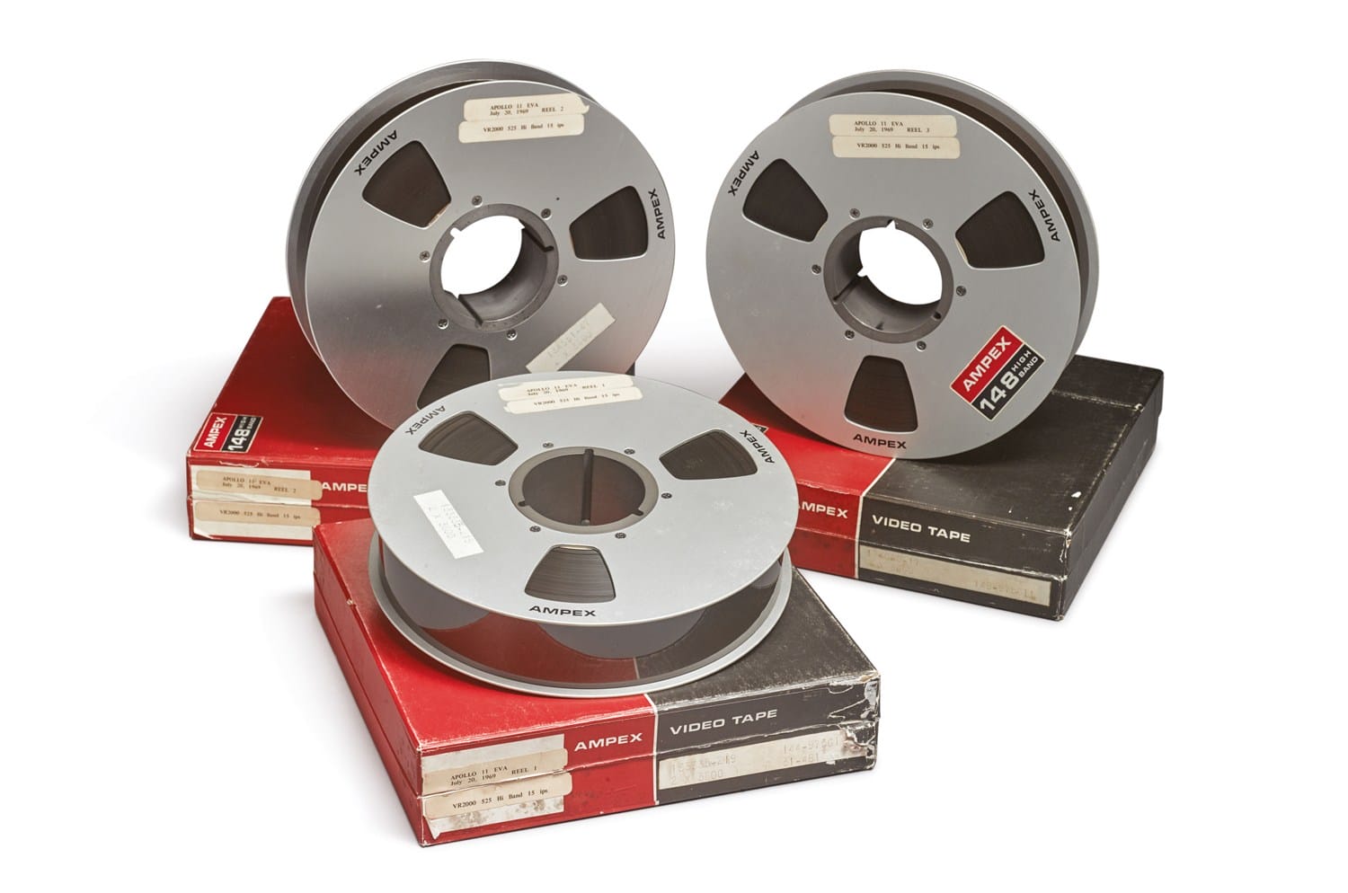 Three vintage Ampex video tape reels on red boxes, showcasing classic analog media storage.