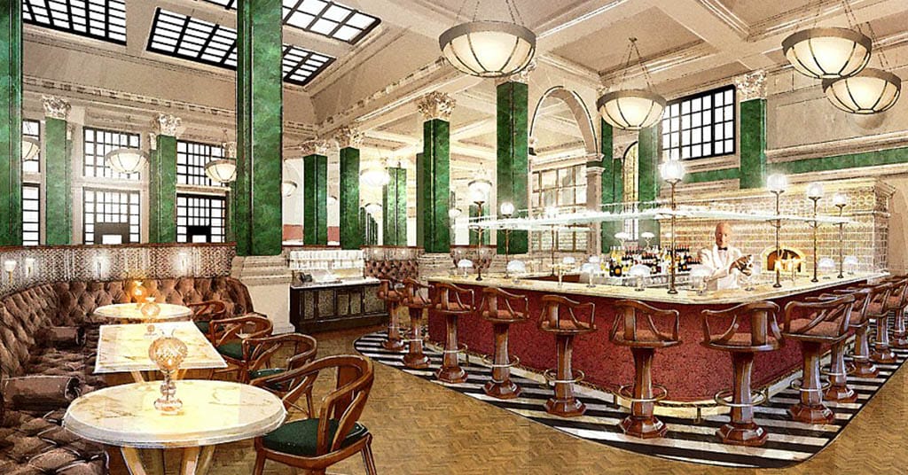 Elegant vintage-style restaurant interior with a central bar, leather seating, and green columns under warm lighting.